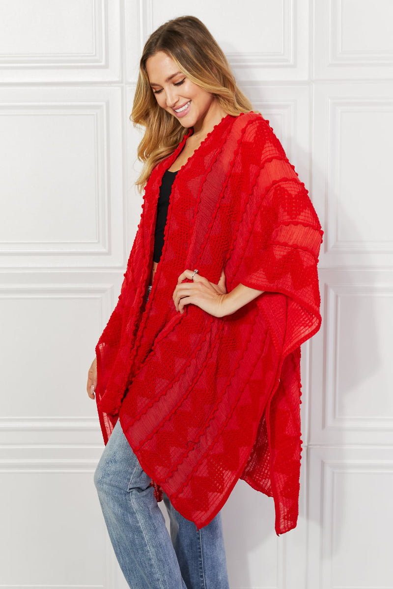 Cardigan poncho asymétrique à pompons Justin Taylor en rouge