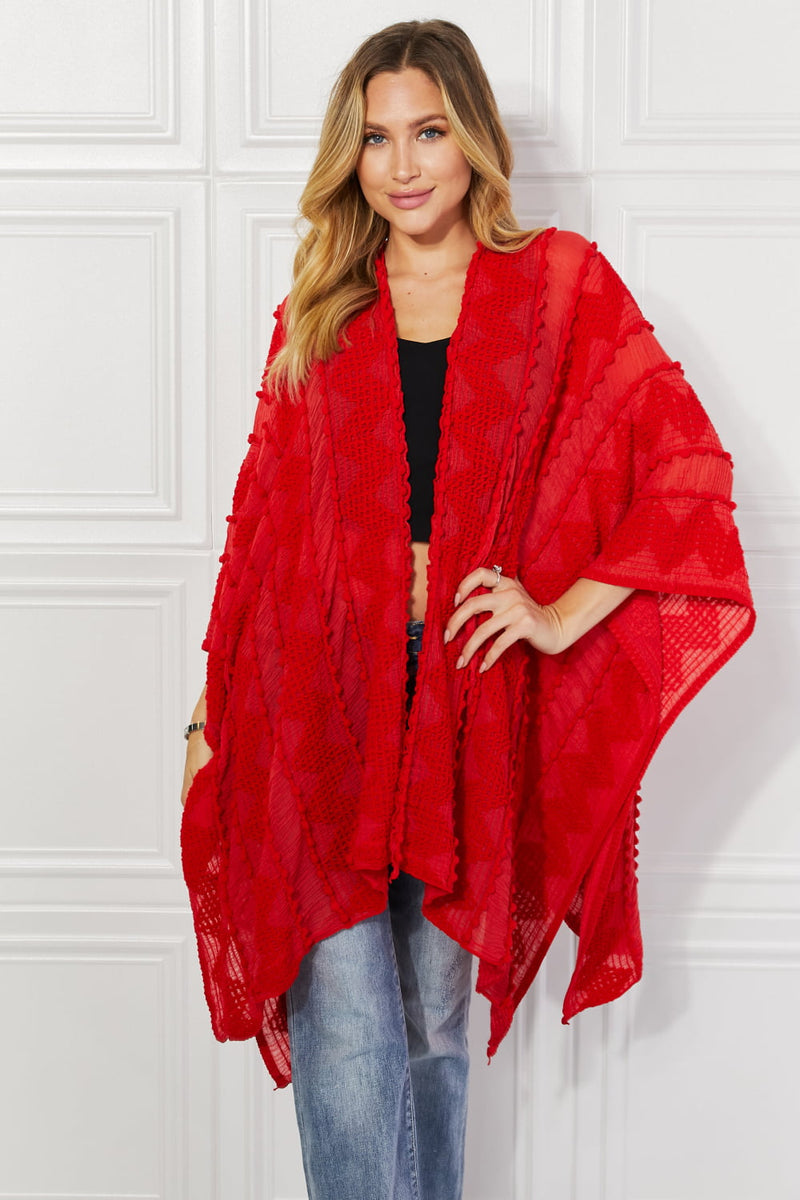 Cardigan poncho asymétrique à pompons Justin Taylor en rouge